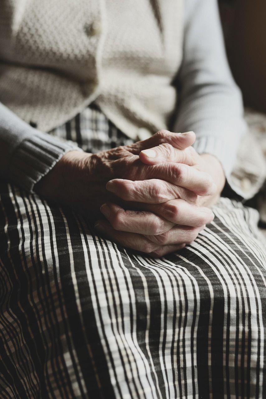 old-woman-holding-her-hands-on-her-lap