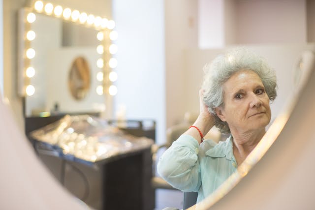 woman-looking-at-hair-cut-in-mirror