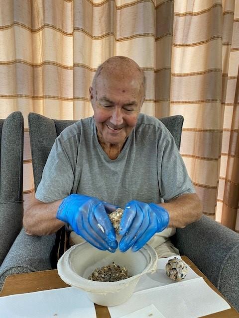 resident making suet balls for the birds 