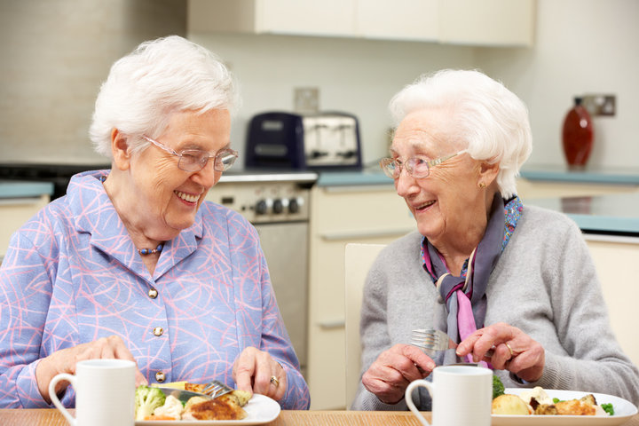 elderly women having lunch together in a care home