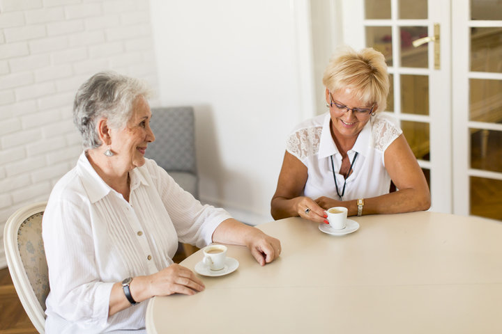 two women talking over coffee