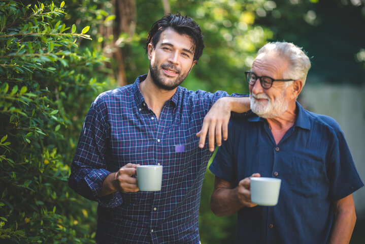 father and son with coffee outside