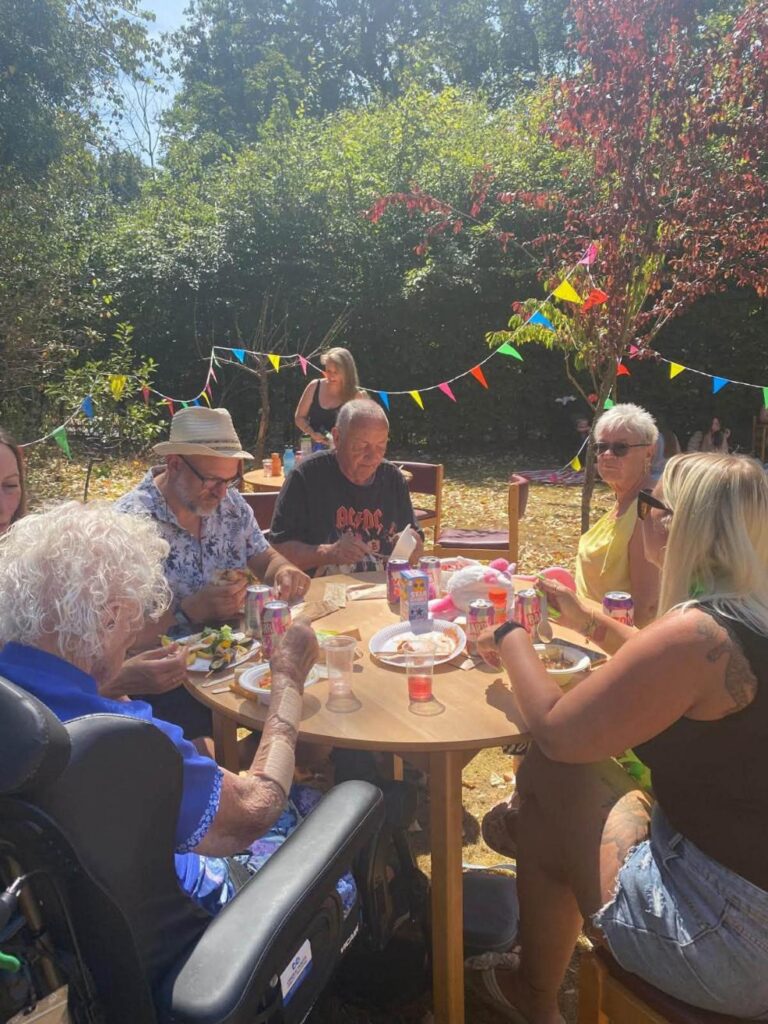 resident with family members eating together in the garden